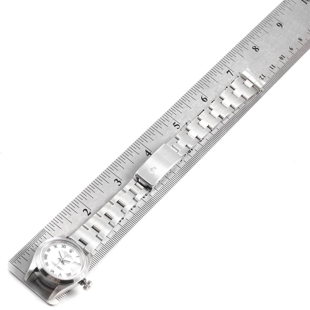 The image shows a Rolex Date 79160 Women's Stainless Steel White Dial 79160 Women's Stainless Steel White Dial model watch laid next to a ruler, highlighting its metal bracelet and clasp.