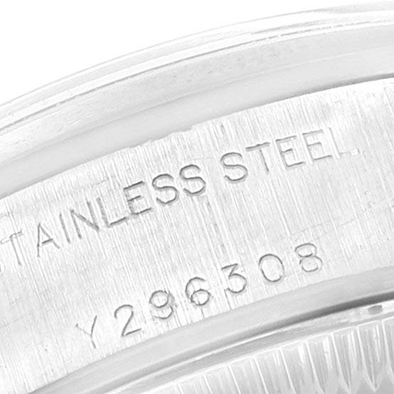 This close-up image shows the stainless steel caseback of a Rolex Date 79160 Women's Stainless Steel White Dial 79160 Women's Stainless Steel White Dial model watch with its serial number and material indicated.