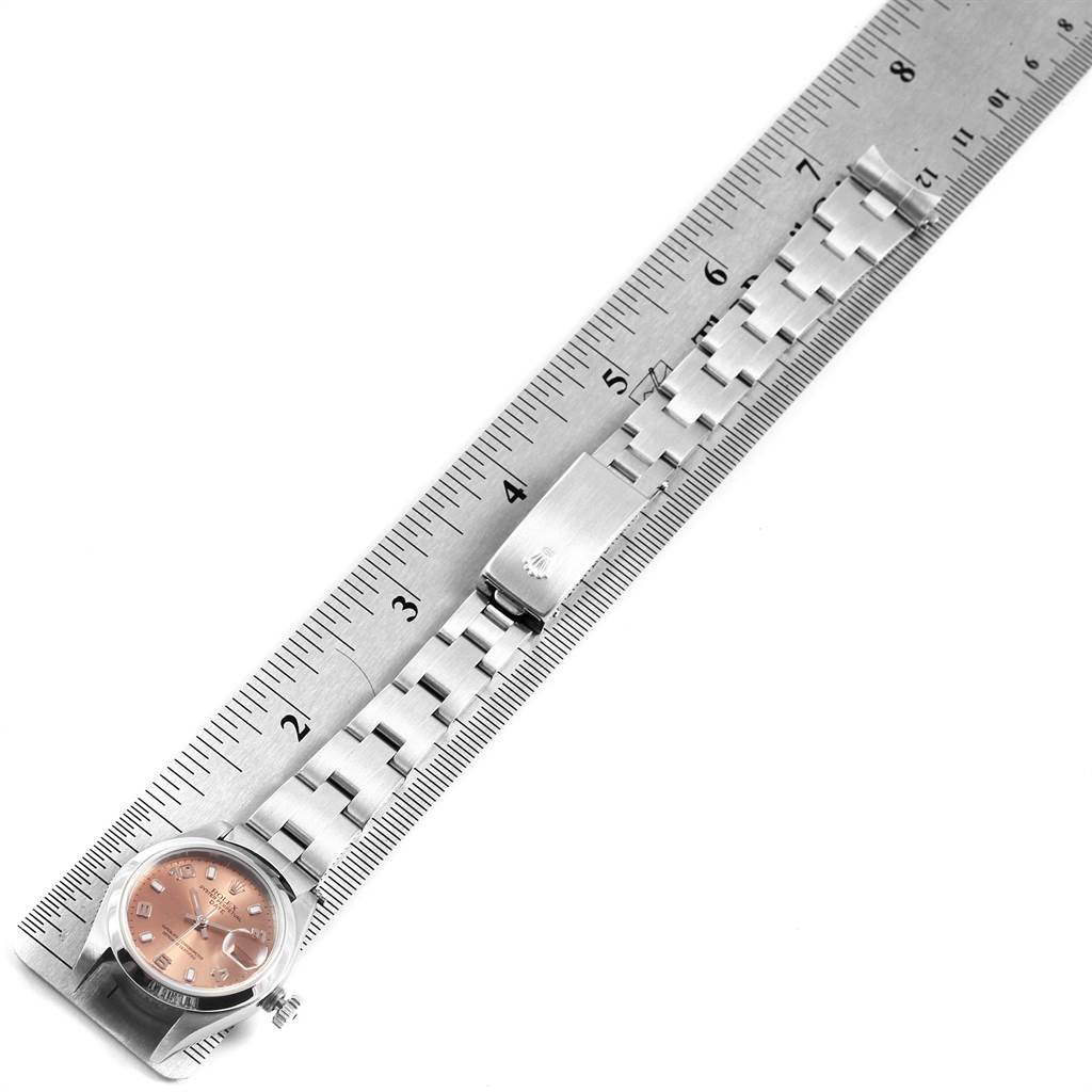 The image shows a Rolex Date 79160 Women's Stainless Steel Pink Dial 79160 Women's Stainless Steel Pink Dial watch laid flat with its bracelet extended alongside a ruler for measurement.