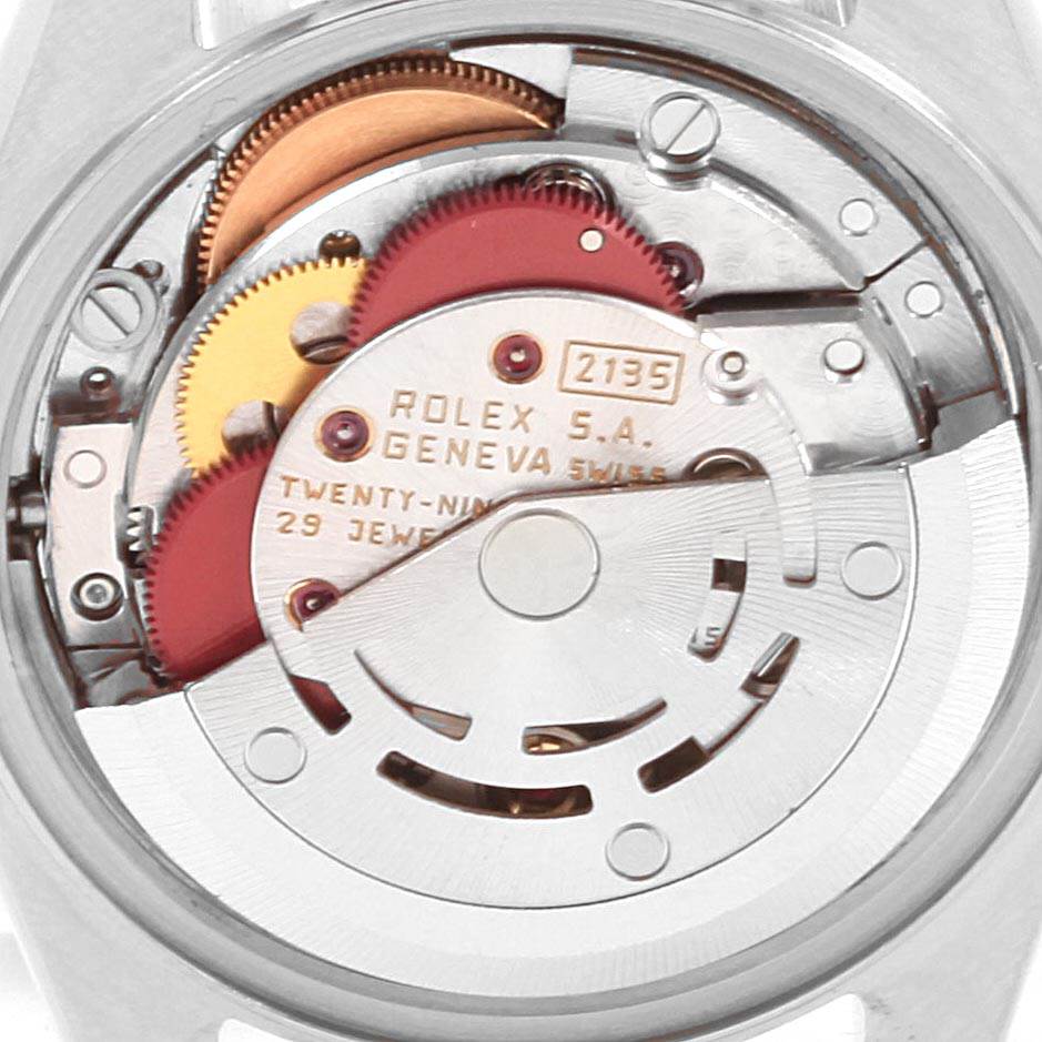 The image shows the internal mechanism of a Rolex Date 69240 Women's Stainless Steel White Dial 69240 Women's Stainless Steel White Dial model watch, highlighting its gears and movement components.