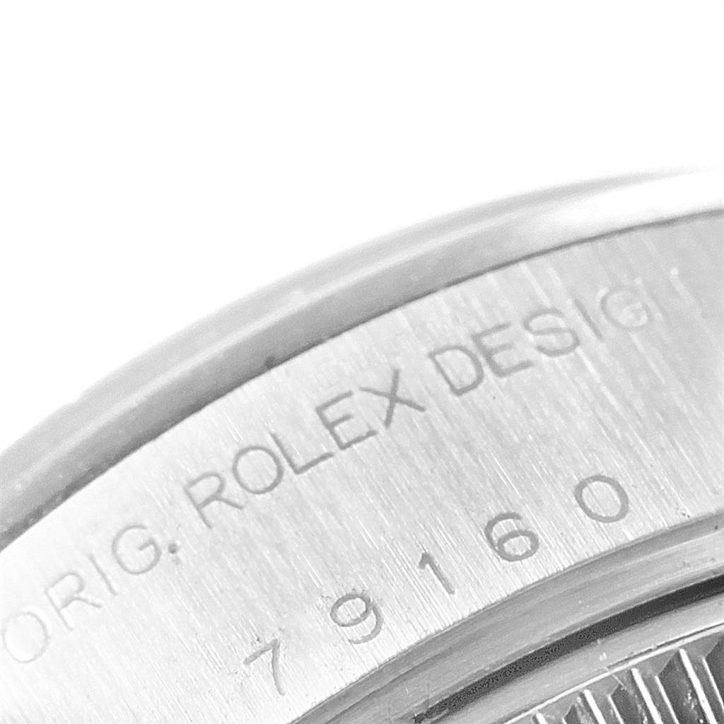 This is a close-up of the side of a Rolex Date 79160 Women
s Stainless Steel Blue Dial 79160 Women
s Stainless Steel Blue Dial model, showing the engraved serial number and design information.