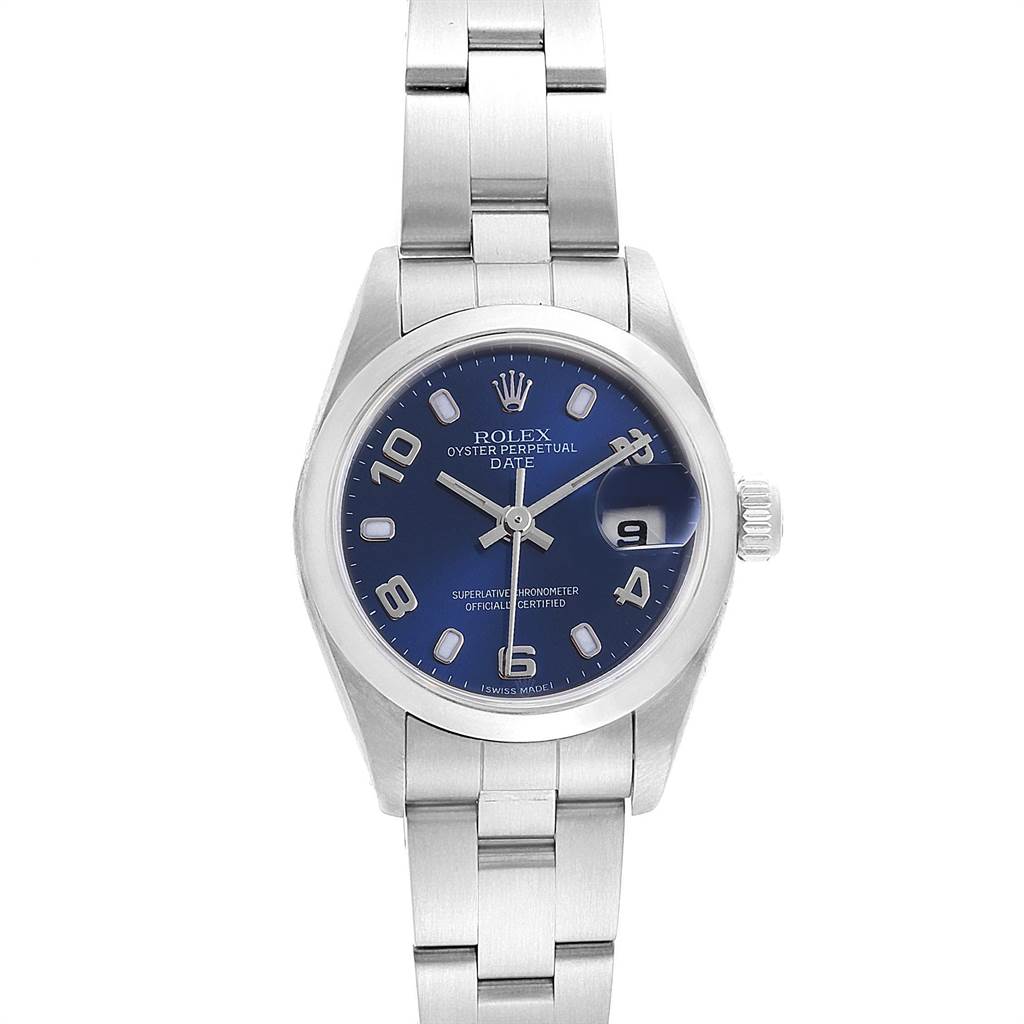 The image shows a front view of a Rolex Oyster Perpetual Date watch, featuring its blue dial, date window, and stainless steel bracelet.