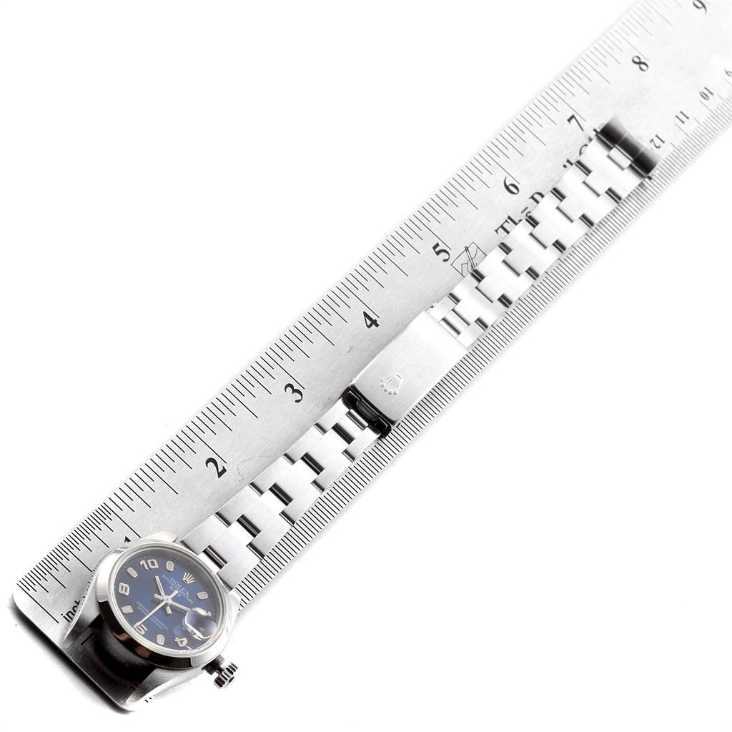 The Rolex Date 79160 Women
s Stainless Steel Blue Dial 79160 Women
s Stainless Steel Blue Dial model watch is shown flat with its bracelet alongside a ruler for measurement.