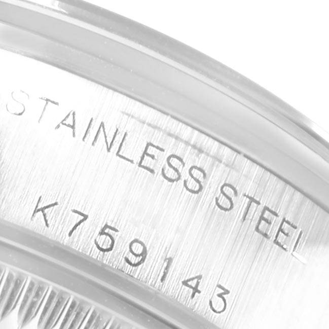 This image shows a close-up of the serial number and "Stainless Steel" inscription on the case of a Rolex Date 79160 Women's Stainless Steel Pink Dial 79160 Women's Stainless Steel Pink Dial watch.