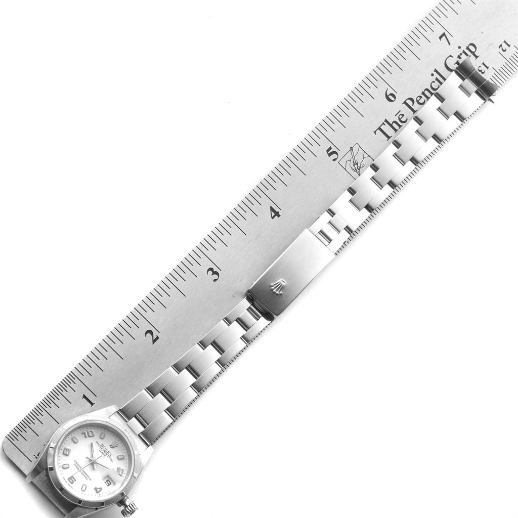 The image shows a Rolex Date 79190 Women's Stainless Steel White Dial 79190 Women's Stainless Steel White Dial model watch from an overhead angle, including its dial, bracelet, and clasp next to a ruler.