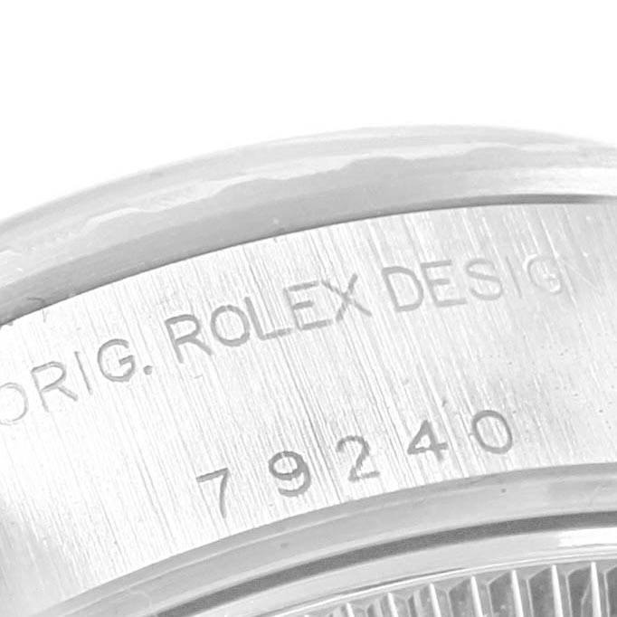 The image shows a close-up angle of the serial and model number engraving on a Rolex Date 79240 Women's Stainless Steel Black Dial 79240 Women's Stainless Steel Black Dial model.