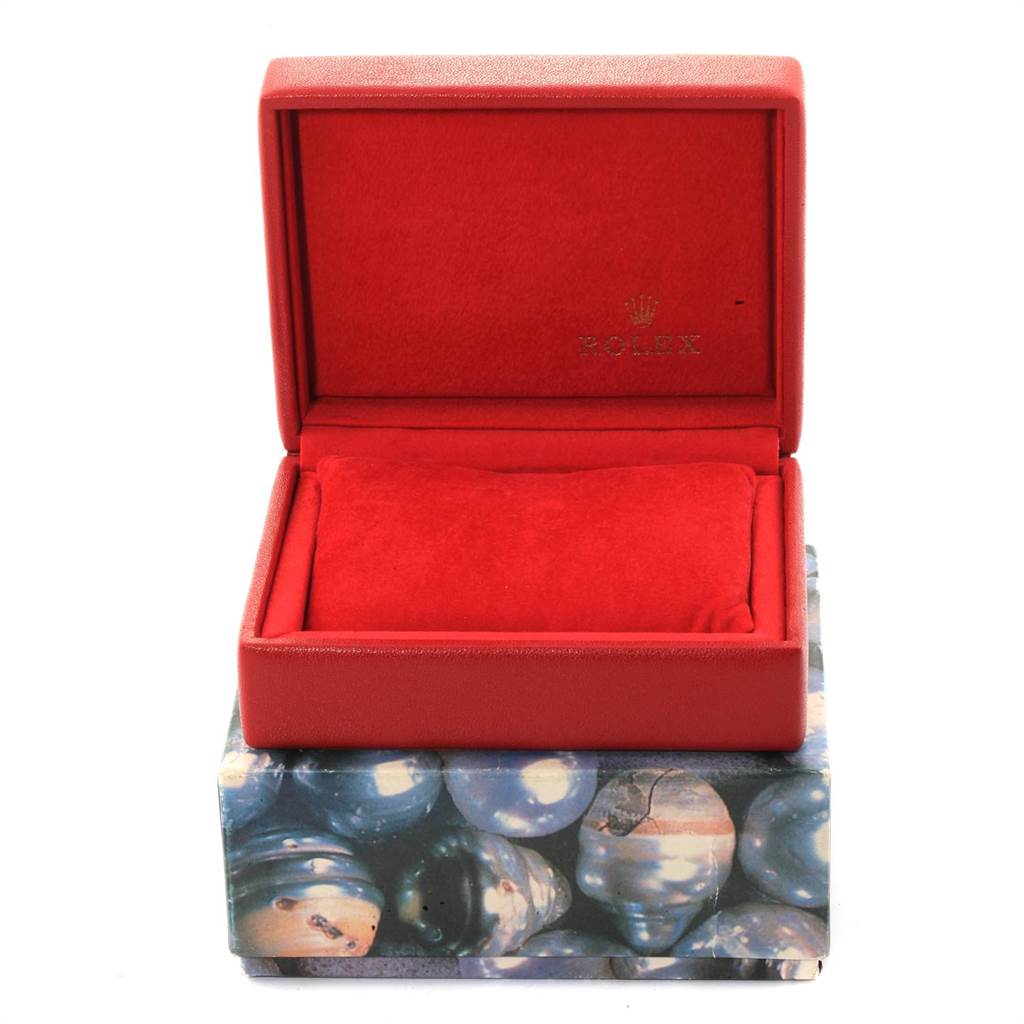 This image shows a red Rolex Date 79240 Women's Stainless Steel Black Dial 79240 Women's Stainless Steel Black Dial watch box and cushion from a front angle.