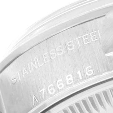 This image shows an angled view of the case back of a Rolex Date 79160 Women's Stainless Steel Blue Dial 79160 Women's Stainless Steel Blue Dial model, highlighting the serial number and "stainless steel" engraving.