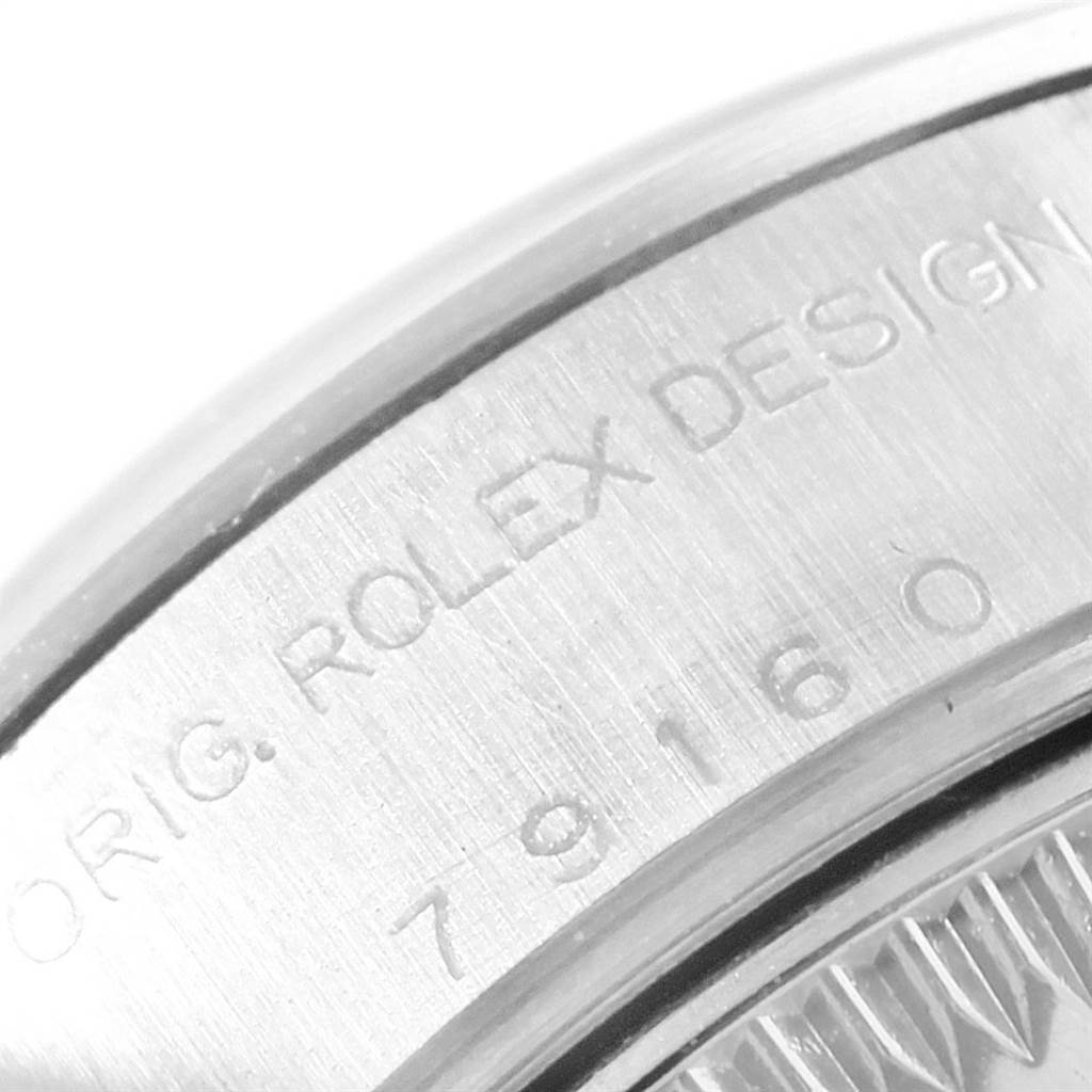 This image shows a close-up of the side engraving on the case of a Rolex Date 79160 Women's Stainless Steel Blue Dial 79160 Women's Stainless Steel Blue Dial model watch.