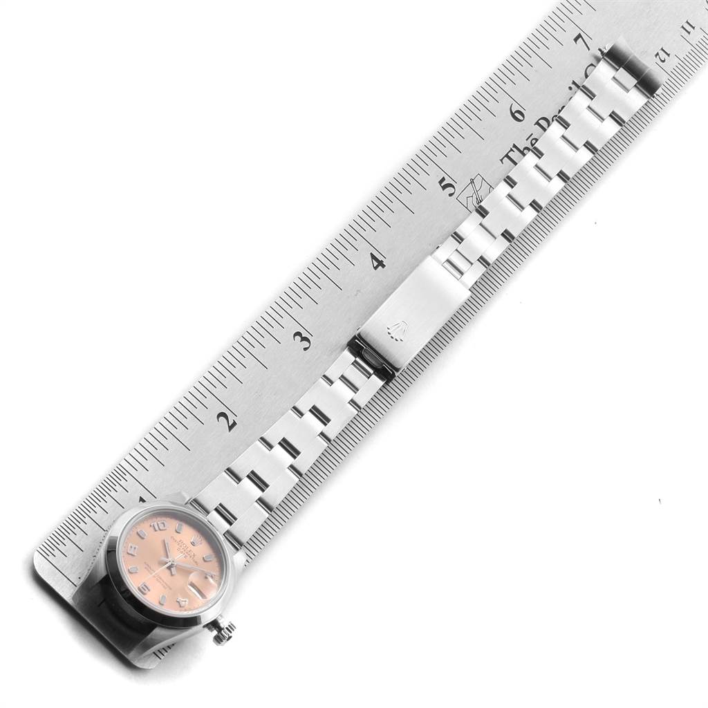 The image shows the Rolex Date 79160 Women's Stainless Steel Pink Dial 79160 Women's Stainless Steel Pink Dial model watch from an overhead angle, including the face, bracelet, and clasp, alongside a ruler for scale.