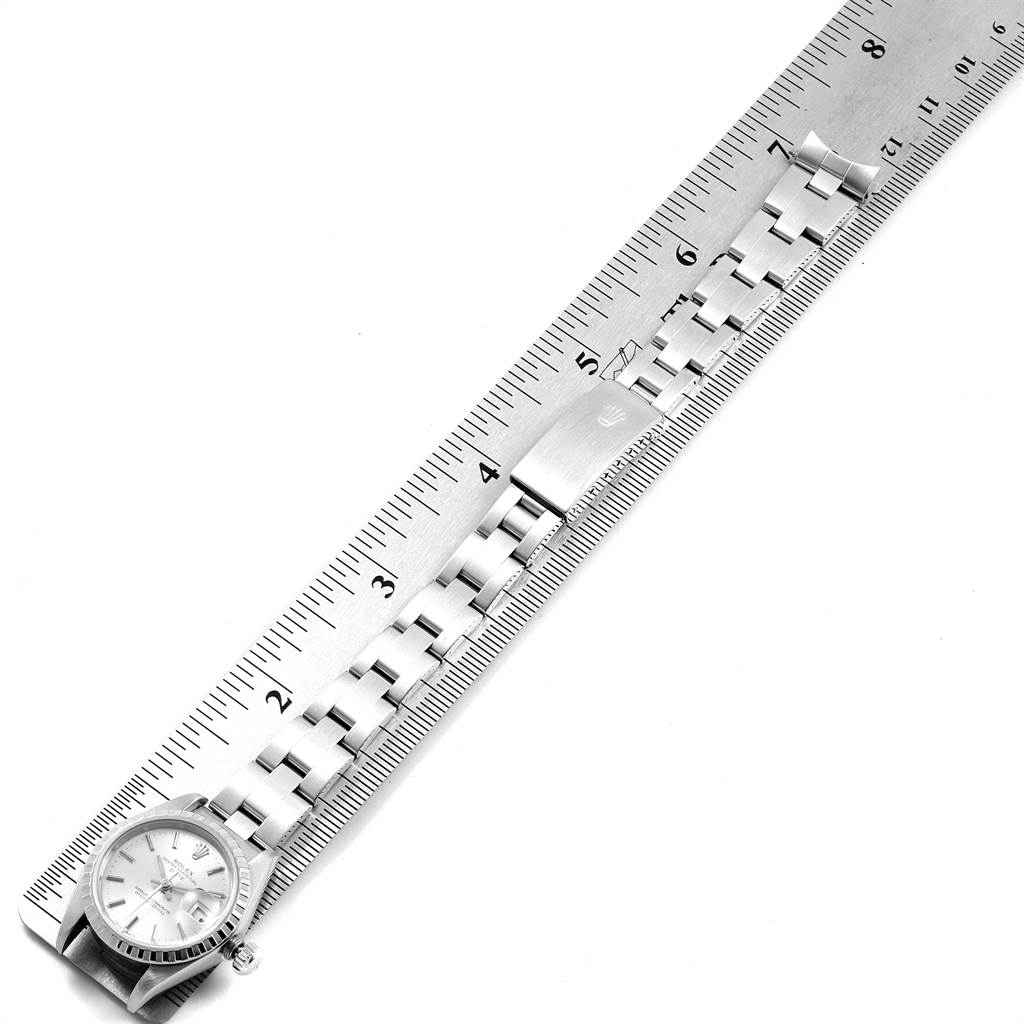 The image shows a top-down view of a Rolex Date 79240 Women's Stainless Steel Silver Dial 79240 Women's Stainless Steel Silver Dial watch, including the watch face and bracelet laid beside a ruler for measurement.