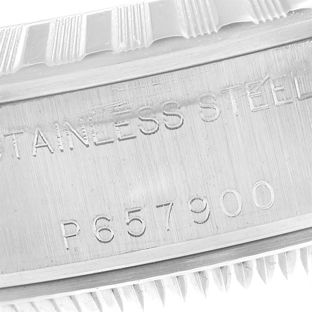 This image shows a close-up of the serial number and text engraved on the side of a Rolex Date 79240 Women's Stainless Steel Silver Dial 79240 Women's Stainless Steel Silver Dial model watch.
