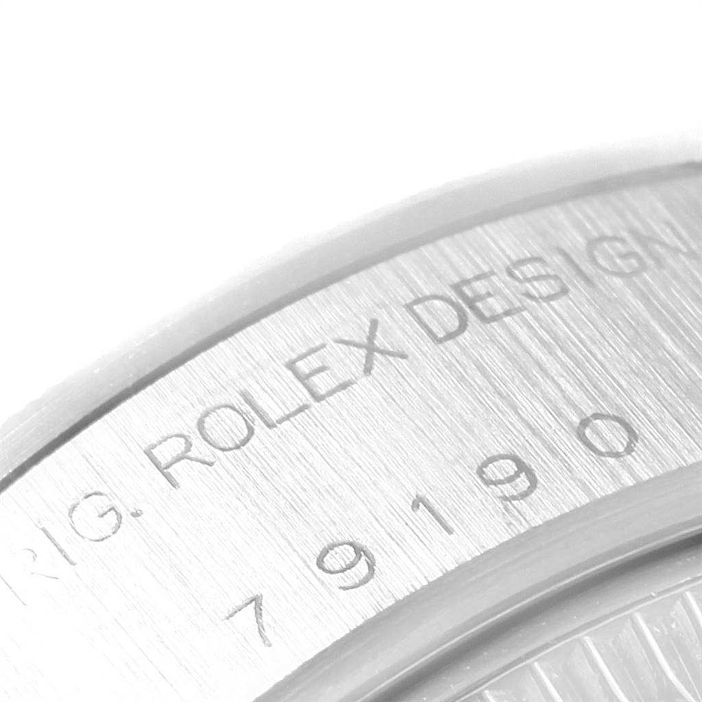 This image shows a close-up of the engraved case back of a Rolex Date 79190 Women
s Stainless Steel Pink Dial 79190 Women
s Stainless Steel Pink Dial model watch.