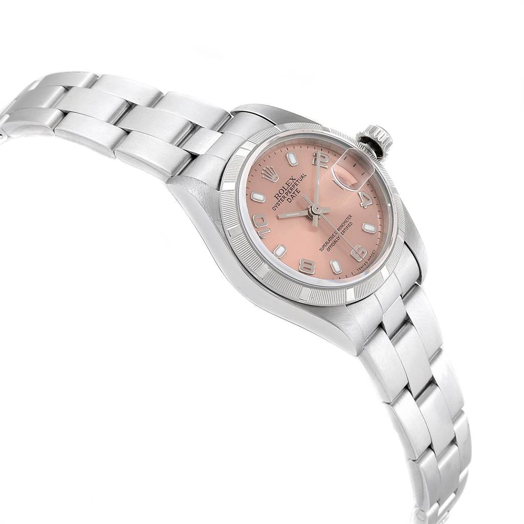The image shows a side angle of the Rolex Date 79190 Women
s Stainless Steel Pink Dial 79190 Women
s Stainless Steel Pink Dial model, featuring its dial, bezel, crown, and part of the bracelet.