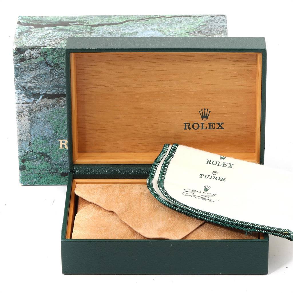 The image shows an open Rolex box for the Date model, including a cleaning cloth and suede pouch.