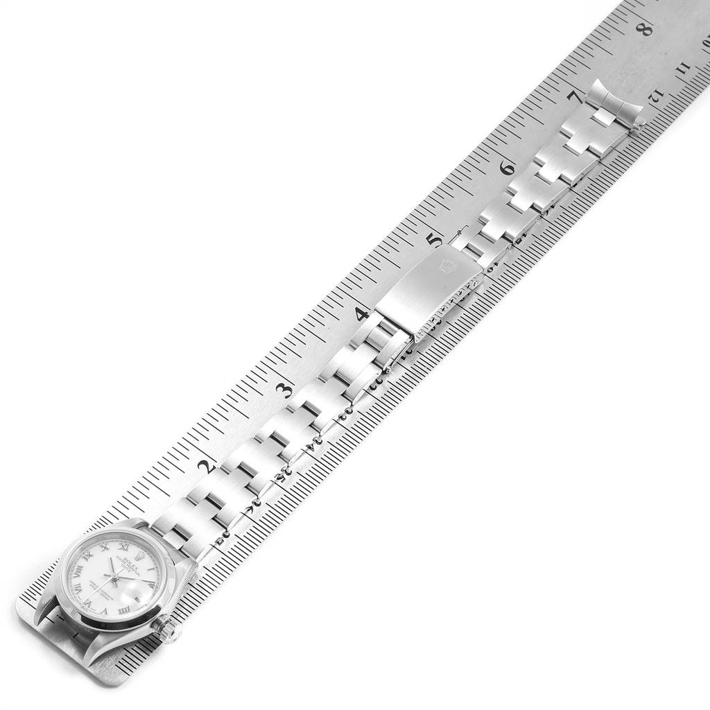 The image shows a Rolex Date 79160 Women
s Stainless Steel White Dial 79160 Women
s Stainless Steel White Dial watch laying flat against a ruler, highlighting the dial, bracelet, and clasp.