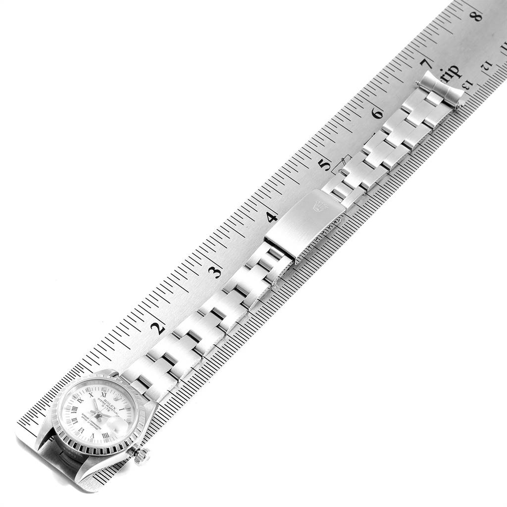The image displays the full length of a Rolex Date 69240 Women's Stainless Steel White Dial 69240 Women's Stainless Steel White Dial model watch and its metal bracelet placed alongside a ruler.