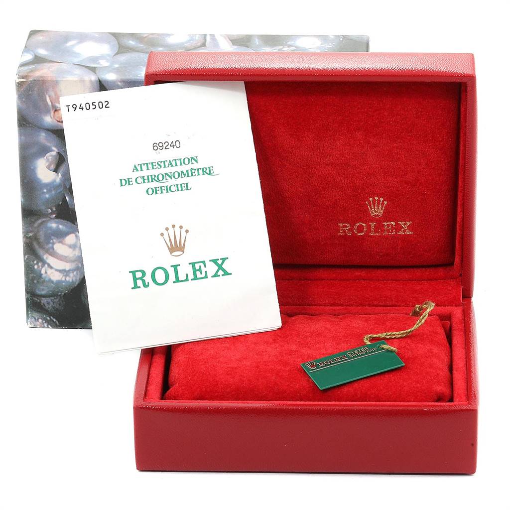 The image shows the packaging contents of a Rolex Date 69240 Women's Stainless Steel White Dial 69240 Women's Stainless Steel White Dial model watch, including a red box, authenticity papers, and a green tag.