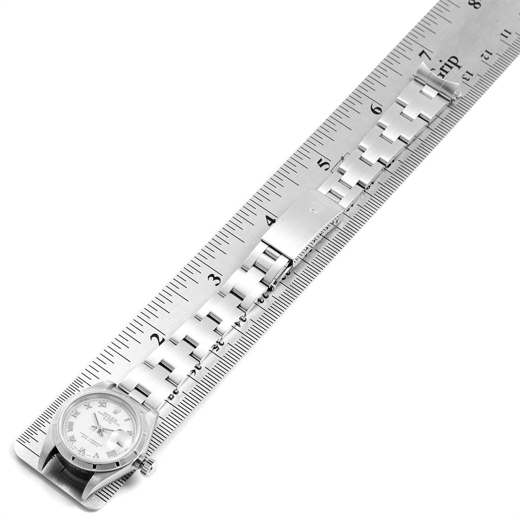 The Rolex Date 79190 Women
s Stainless Steel White Dial 79190 Women
s Stainless Steel White Dial watch is shown flat, with its face, bracelet, and clasp beside a ruler for size reference.