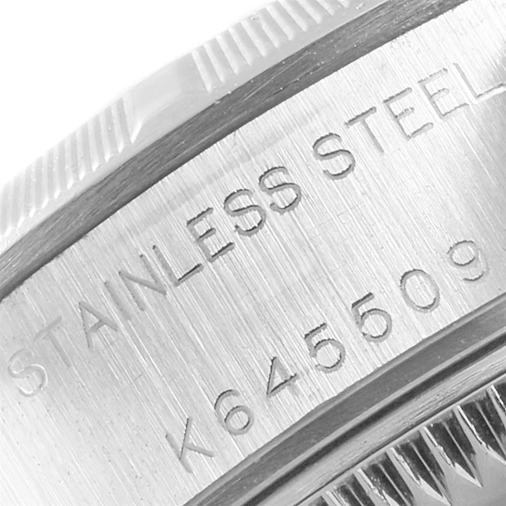 This is a close-up image of the case back of a Rolex Date 79190 Women
s Stainless Steel White Dial 79190 Women
s Stainless Steel White Dial model, showing the serial number and "STAINLESS STEEL" engraving.
