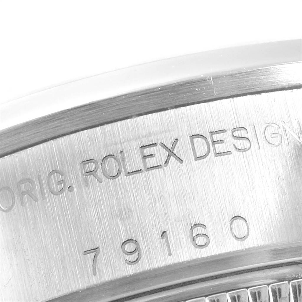 This close-up image shows the engraved serial number and "ROLEX DESIGN" on the side of the Rolex Date 79160 Women
s Stainless Steel Blue Dial 79160 Women
s Stainless Steel Blue Dial watch case.