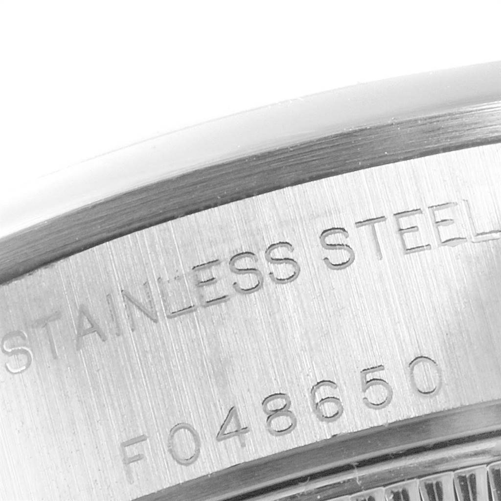 The image shows a close-up angle of the stainless steel back case of a Rolex Date 79160 Women
s Stainless Steel Blue Dial 79160 Women
s Stainless Steel Blue Dial watch.