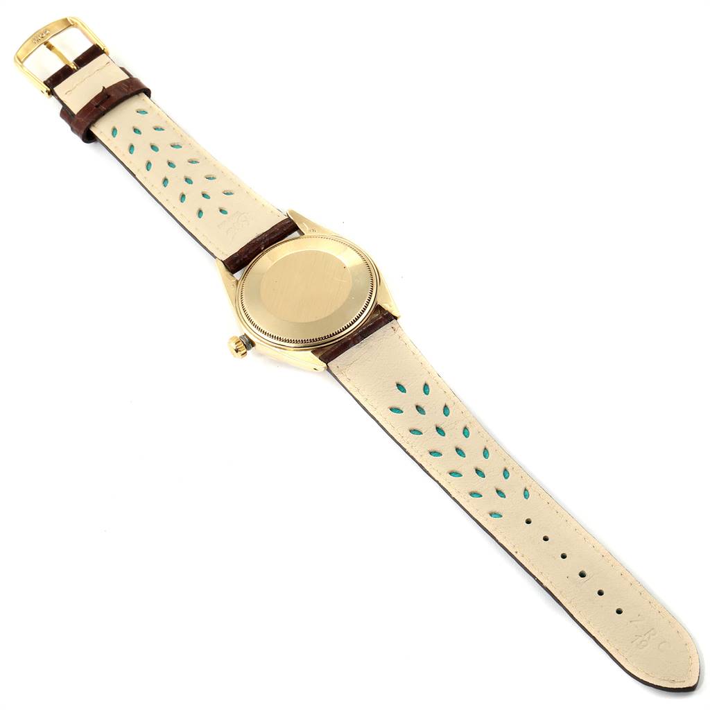 This image shows the back view of a Rolex Date 1503 Men's Yellow Gold Champagne Dial 1503 Men's Yellow Gold Champagne Dial model watch, along with its leather strap.