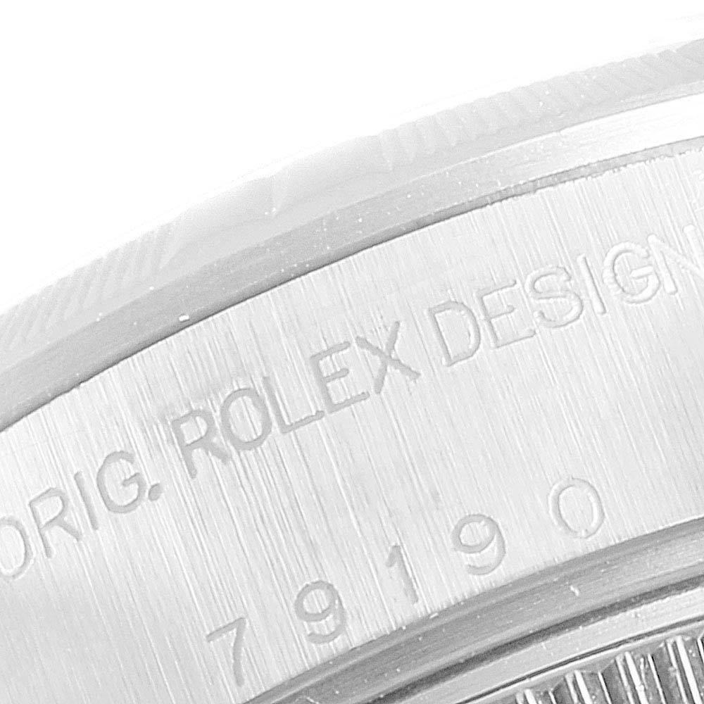 The image shows a close-up of the case back engraving of a Rolex Date 79190 Women
s Stainless Steel Pink Dial 79190 Women
s Stainless Steel Pink Dial model watch.