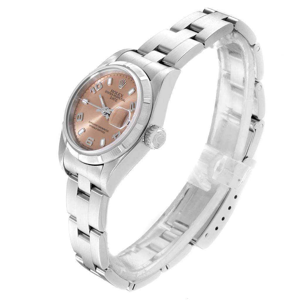 The image shows a Rolex Date 79190 Women
s Stainless Steel Pink Dial 79190 Women
s Stainless Steel Pink Dial model watch from a side angle, highlighting the dial, bezel, crown, and bracelet.