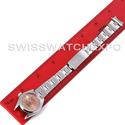 The image shows a Rolex Date 79160 Women's Stainless Steel Pink Dial 79160 Women's Stainless Steel Pink Dial model watch laid flat with its metal bracelet extended along a red ruler.