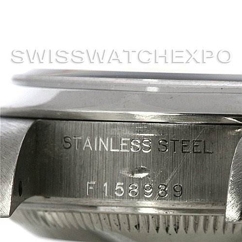 This image shows a side view of the case of a Rolex Date 79160 Women's Stainless Steel White Dial 79160 Women's Stainless Steel White Dial model watch, highlighting the "STAINLESS STEEL" engraving and the serial number.