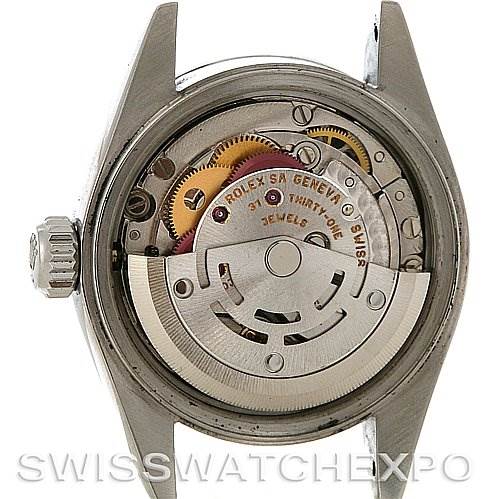 The image shows the rear side internals of a Rolex Date 79160 Women's Stainless Steel White Dial 79160 Women's Stainless Steel White Dial model, highlighting its intricate movement and components.