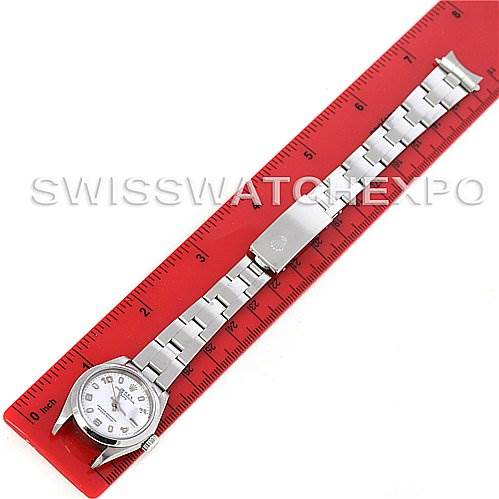 This image shows a Rolex Date 79160 Women's Stainless Steel White Dial 79160 Women's Stainless Steel White Dial model watch placed flat against a red ruler, displaying its face and full bracelet.
