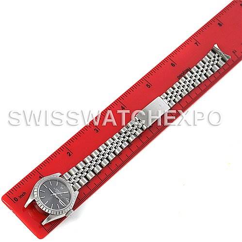 The image shows a Rolex Date 69240 Women's Stainless Steel Grey Dial 69240 Women's Stainless Steel Grey Dial model watch laid flat on a red ruler, displaying the face and stainless steel bracelet.