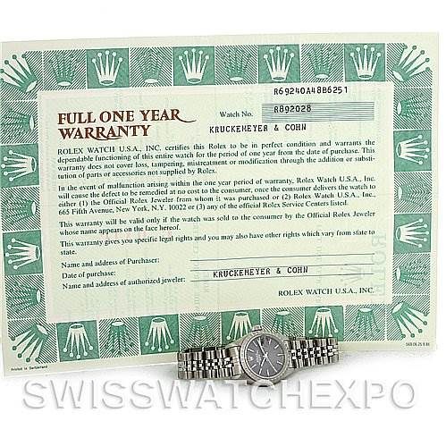 The image shows a Rolex Date 69240 Women's Stainless Steel Grey Dial 69240 Women's Stainless Steel Grey Dial watch laying flat, accompanied by its warranty papers.