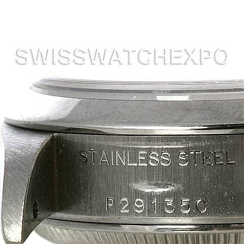 This image shows a side view of the case and lugs of a Rolex Date 79160 Women's Stainless Steel Silver Dial 79160 Women's Stainless Steel Silver Dial model watch, with the words "STAINLESS STEEL" and a serial number engraved.