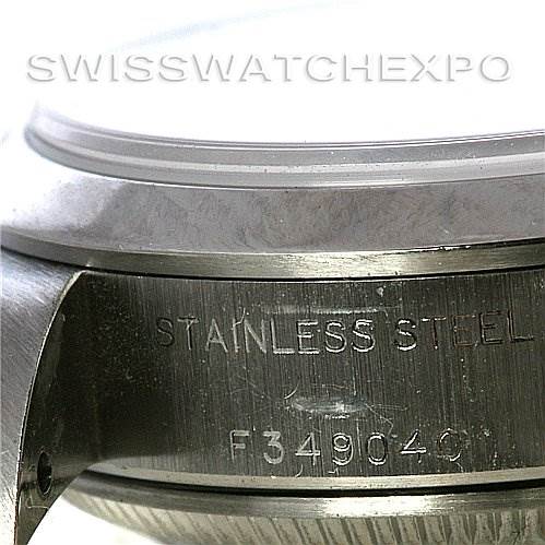 This close-up image shows the side of a Rolex Date 79160 Women
s Stainless Steel White Dial 79160 Women
s Stainless Steel White Dial model watch case, displaying the "STAINLESS STEEL" engraving and serial number.