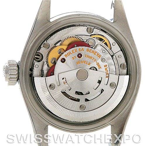 The image shows the back view of a Rolex Date 79190 Women's Stainless Steel Black Dial 79190 Women's Stainless Steel Black Dial model watch, displaying its mechanical movement and gears.