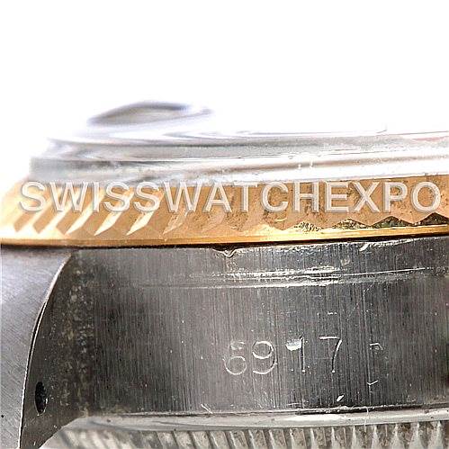 The image shows a close-up of the side of a Rolex Date 6917 Women's Stainless Steel Silver Dial 6917 Women's Stainless Steel Silver Dial model watch, focusing on the bezel, case, and part of the engraved serial number.