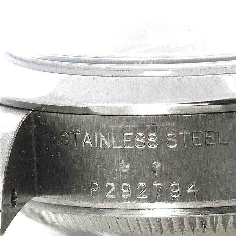 This is a close-up side view of the serial number and stainless steel engraving on a Rolex Date 79160 Women's Stainless Steel Blue Dial 79160 Women's Stainless Steel Blue Dial model watch case.