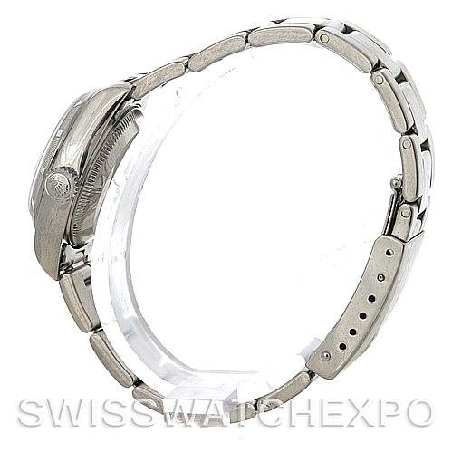 This side-view image of a Rolex Date 79190 Women's Stainless Steel White Dial 79190 Women's Stainless Steel White Dial model shows the watch case, crown, and metal bracelet.