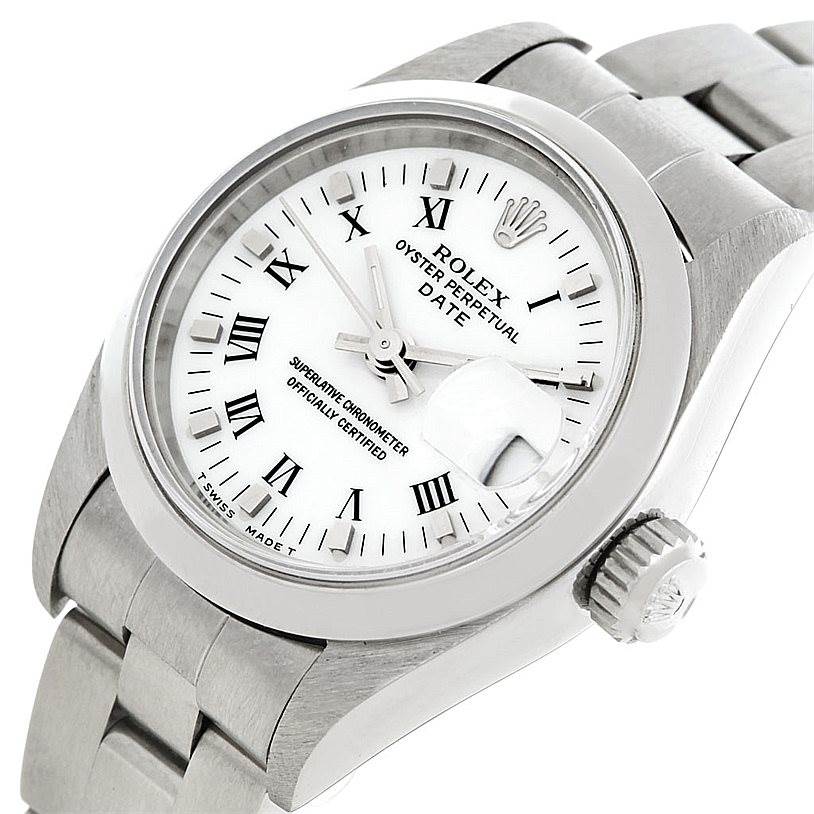 This image displays a close-up, angled view of the Rolex Date 69160 Women's Stainless Steel White Dial 69160 Women's Stainless Steel White Dial model watch, showing the dial, bezel, crown, and part of the bracelet.