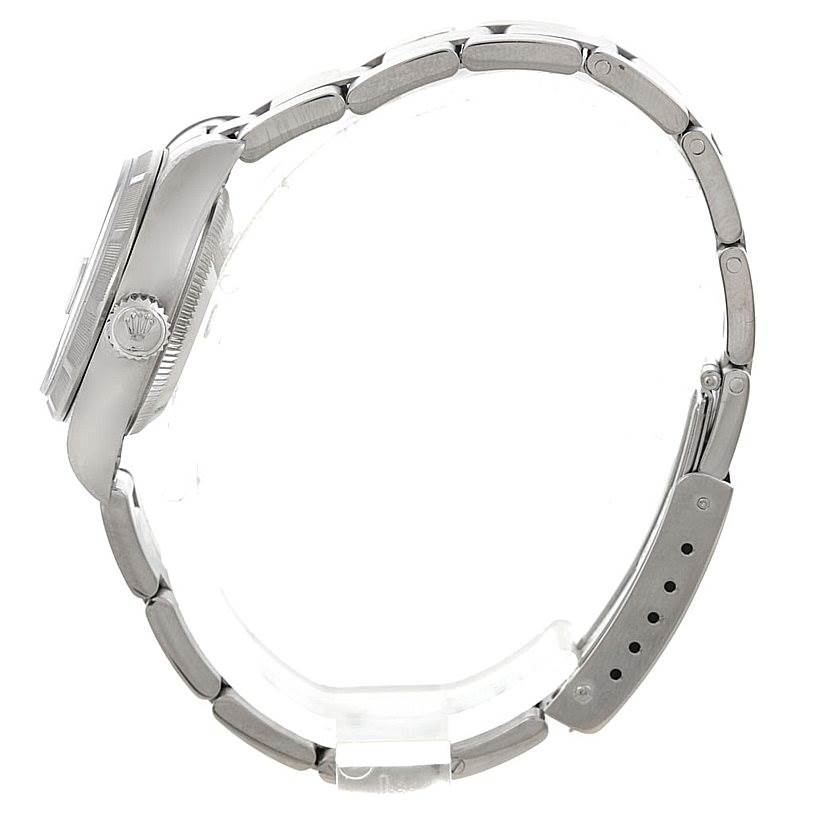 This side view of the Rolex Date 79190 Women's Stainless Steel Blue Dial 79190 Women's Stainless Steel Blue Dial model watch shows the crown, case, and metal bracelet.