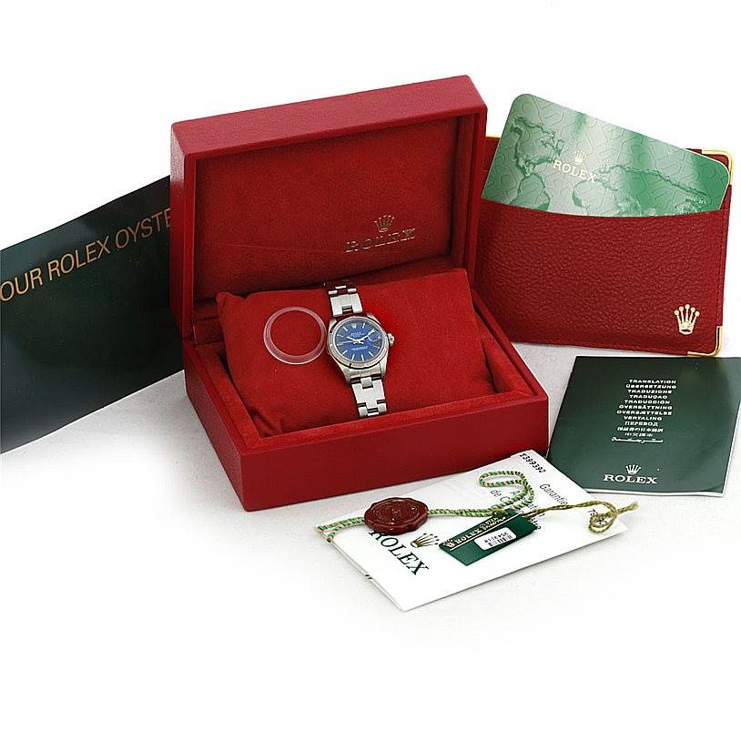 The Rolex Date 79190 Women's Stainless Steel Blue Dial 79190 Women's Stainless Steel Blue Dial watch is shown in its box with a blue dial, along with accompanying accessories including booklets, tags, and a certificate.