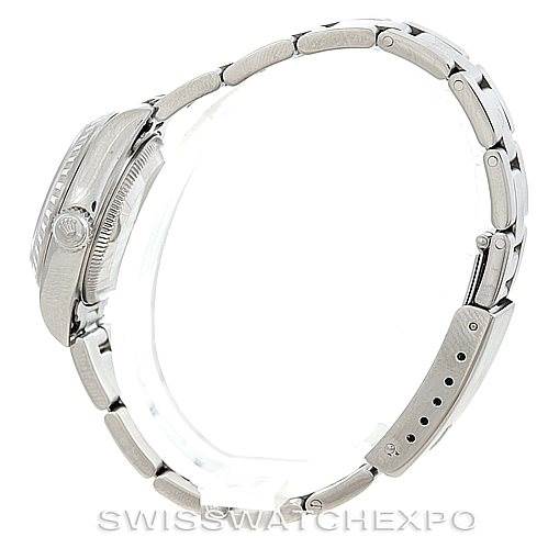 This side-angle view of the Rolex Date 79240 Women's Stainless Steel Pink Dial 79240 Women's Stainless Steel Pink Dial model watch shows the bracelet, clasp, crown, and case.