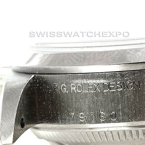 This close-up shows the case side of a Rolex Date 79160 Women's Stainless Steel Pink Dial 79160 Women's Stainless Steel Pink Dial model, highlighting the engraved text and part of the bezel and crown.