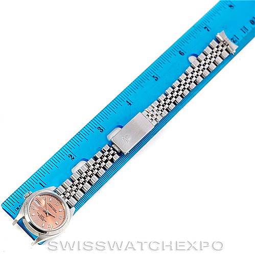 The image shows a Rolex Date 79160 Women's Stainless Steel Pink Dial 79160 Women's Stainless Steel Pink Dial model watch with a pink dial and a jubilee bracelet, placed next to a blue ruler for scale.