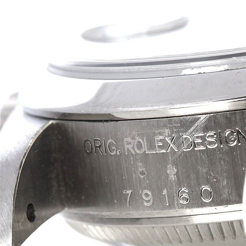 The image shows a close-up angle of the side of the Rolex Date 79240 Women's Stainless Steel Blue Dial 79240 Women's Stainless Steel Blue Dial model watch, specifically the engraved case with the serial number and "ORIG. ROLEX DESIGN".