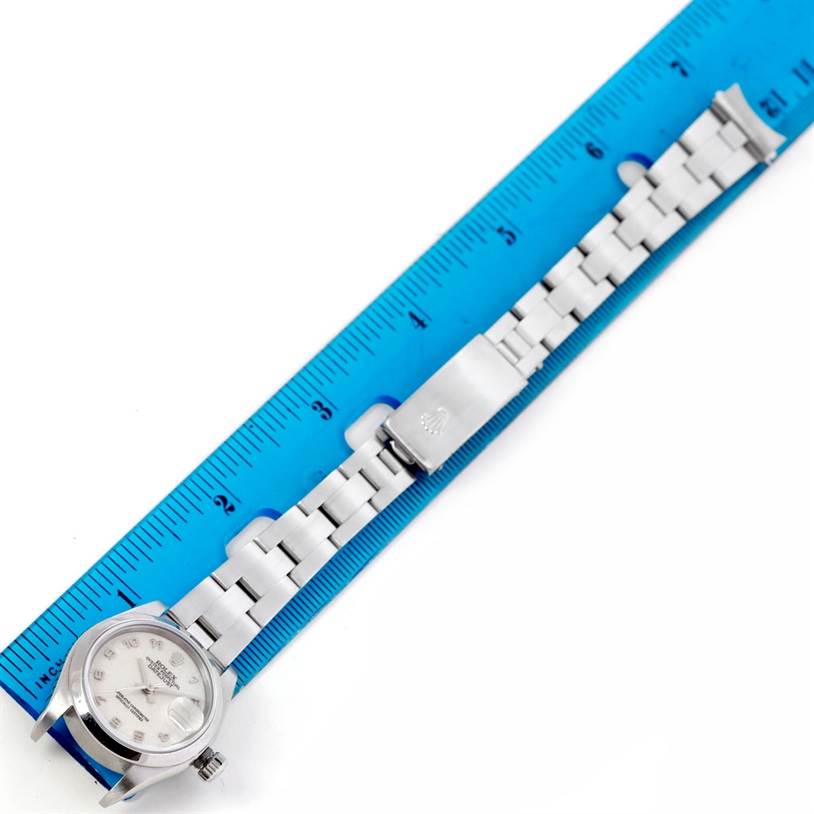 The image shows a lay-flat view of a Rolex Date 79160 Women's Stainless Steel Beige Dial 79160 Women's Stainless Steel Beige Dial model watch, featuring the dial, bracelet, and clasp, alongside a ruler for scale.