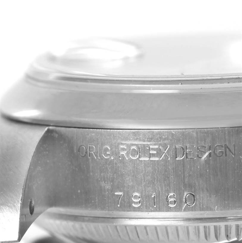This image shows a close-up side view of the case of a Rolex Date 79160 Women's Stainless Steel Beige Dial 79160 Women's Stainless Steel Beige Dial model watch, focusing on the engraved model number and design text.